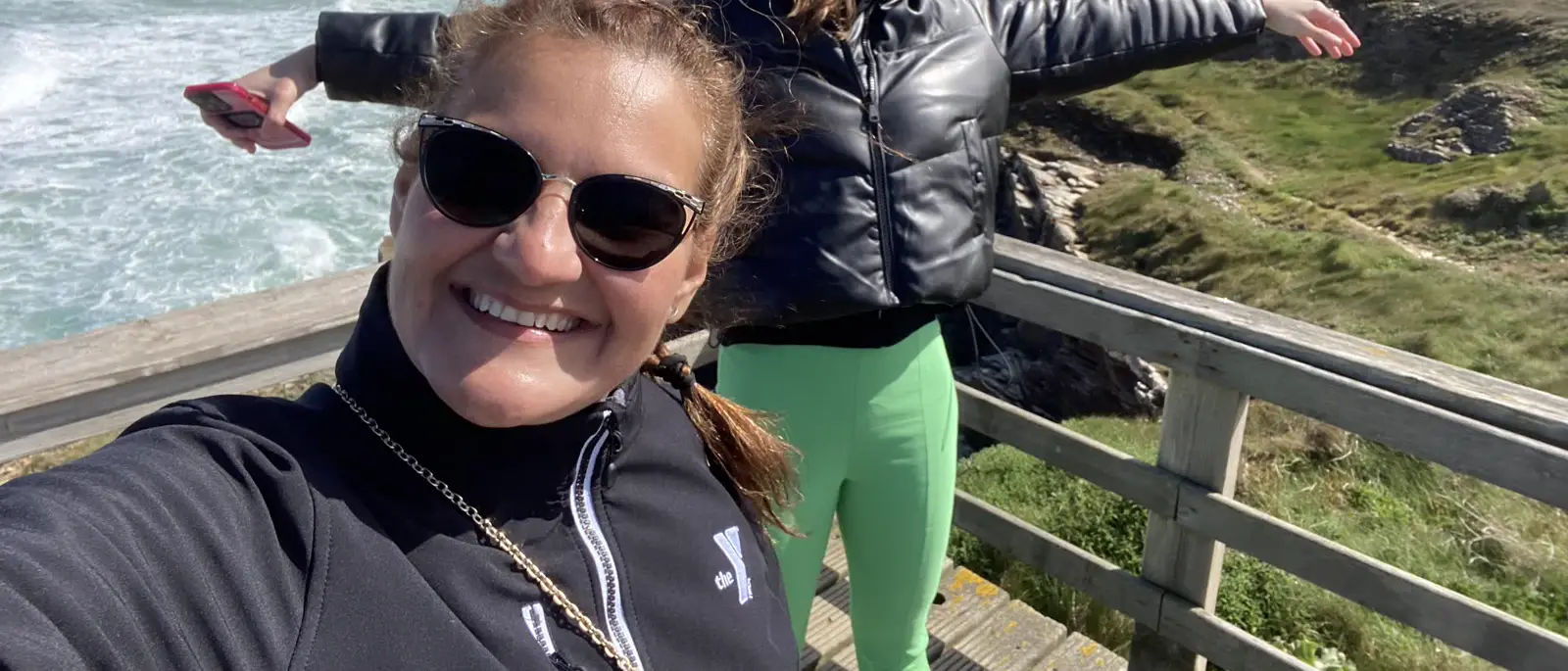 Estela smiling at a coastal overlook on the Camino del Norte